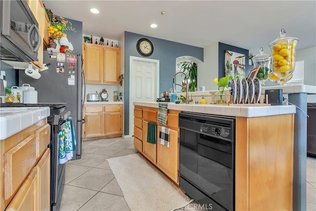 11244 Sega Ln, Fontana, CA 92337 - kitchen featuring range, light brown cabinetry, tile counters, black dishwasher, and recessed lighting