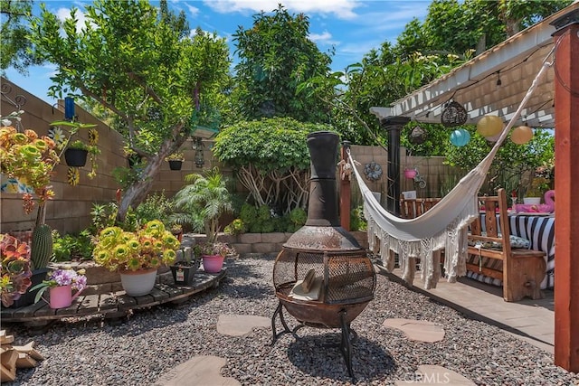 11244 Sega Ln, Fontana, CA 92337 - fenced backyard with an outdoor fire pit, a patio area, and a pergola