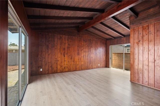 150 E 232nd St, Carson, CA 90745 - unfurnished living room featuring wooden walls, light wood-style flooring, and wooden ceiling