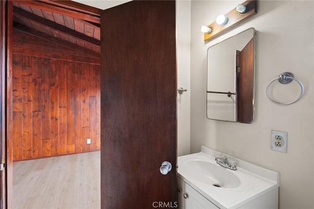 150 E 232nd St, Carson, CA 90745 - bathroom featuring vanity, wood finished floors, and wooden walls