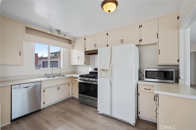 150 E 232nd St, Carson, CA 90745 - kitchen with stainless steel appliances, cream cabinets, and light countertops