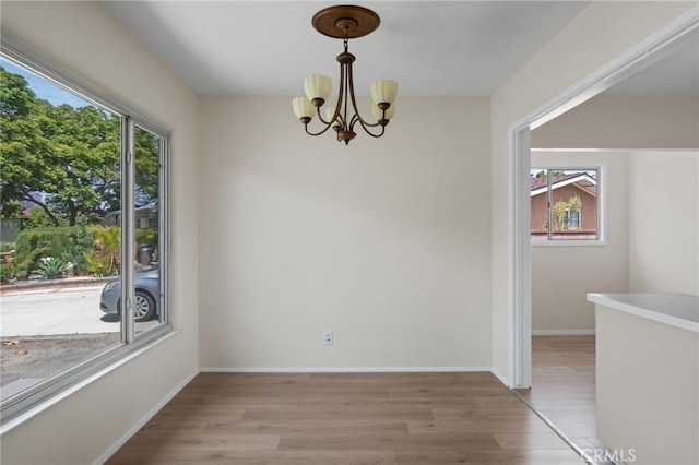 150 E 232nd St, Carson, CA 90745 - unfurnished dining area featuring light wood-type flooring and a chandelier