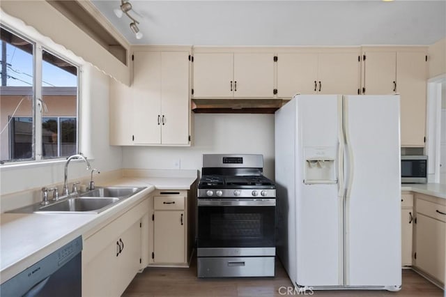 150 E 232nd St, Carson, CA 90745 - kitchen with appliances with stainless steel finishes, cream cabinets, under cabinet range hood, and light countertops