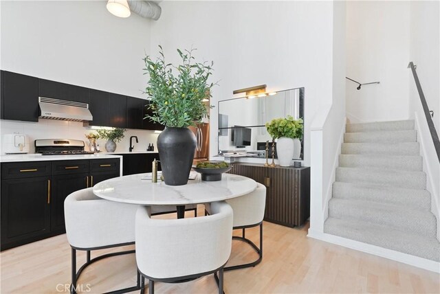 4215 Glencoe Ave Unit 407, Marina Del Rey, CA 90292 - dining space featuring light wood finished floors, stairway, and a high ceiling