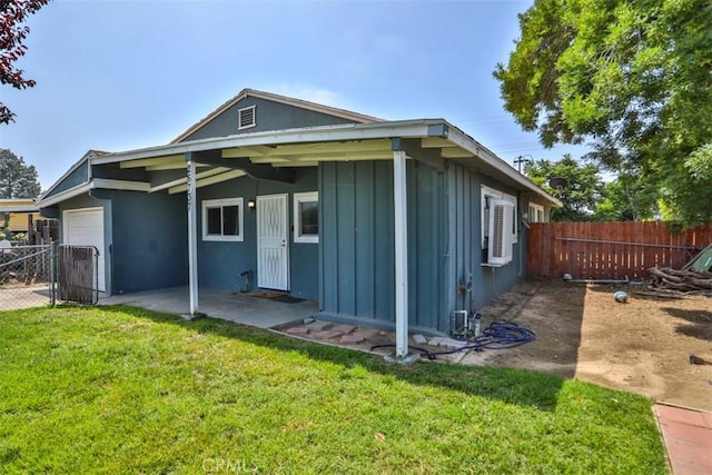 26737 Cypress St, Highland, CA 92346 - rear view of property with board and batten siding, a garage, and a patio