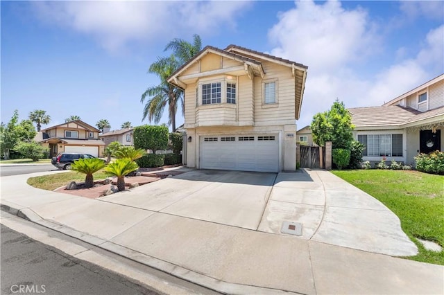 13519 Fremont St, Fontana, CA 92336 - view of front of home with an attached garage, driveway, stucco siding, and a tile roof