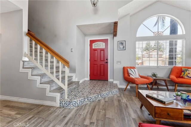 13519 Fremont St, Fontana, CA 92336 - foyer entrance with wood finished floors, stairway, and high vaulted ceiling