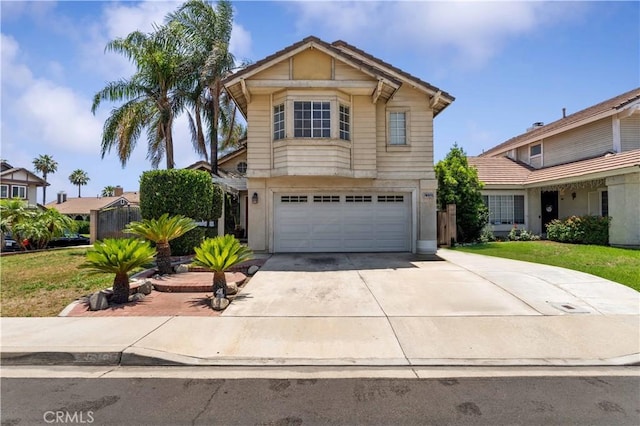 13519 Fremont St, Fontana, CA 92336 - view of front facade with an attached garage, driveway, a tiled roof, and stucco siding