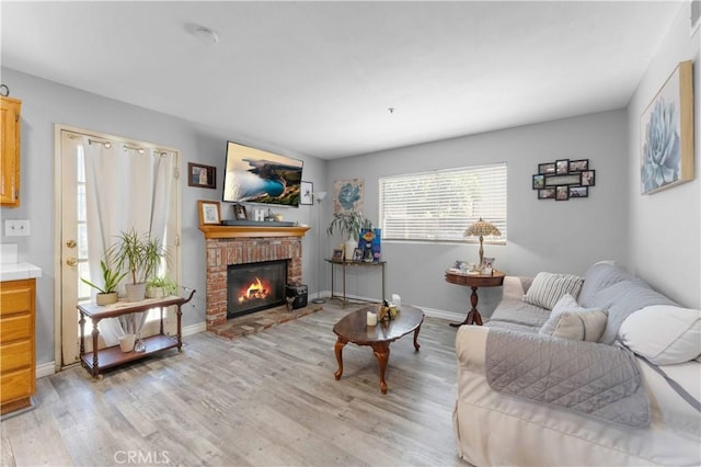 13519 Fremont St, Fontana, CA 92336 - living room featuring light wood finished floors and a fireplace