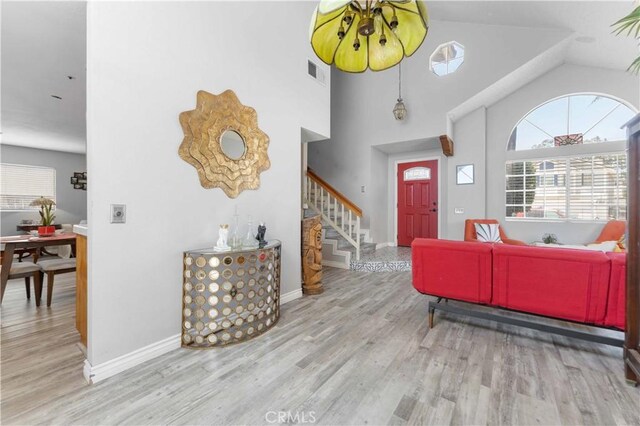 13519 Fremont St, Fontana, CA 92336 - entrance foyer featuring healthy amount of natural light, stairs, wood finished floors, and high vaulted ceiling