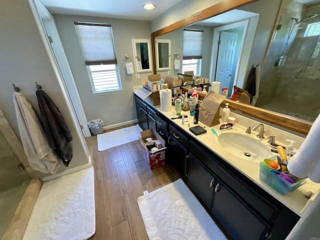 1917 Tecate, Escondido, CA 92029 - full bath with double vanity, a shower stall, healthy amount of natural light, and wood finished floors