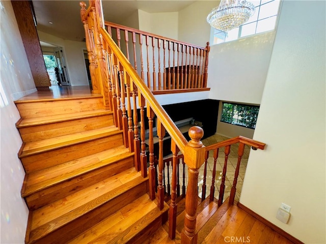 14542 Los Robles Ave, Hacienda Heights, CA 91745 - staircase with wood-type flooring, plenty of natural light, and a chandelier