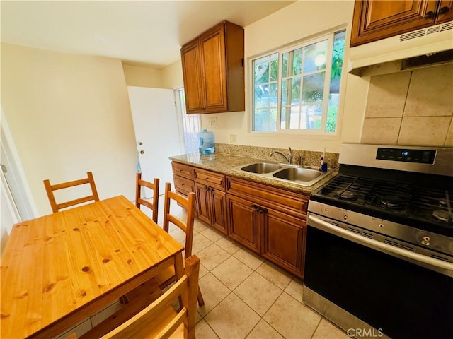 14542 Los Robles Ave, Hacienda Heights, CA 91745 - kitchen featuring gas range, extractor fan, brown cabinetry, and light tile patterned floors