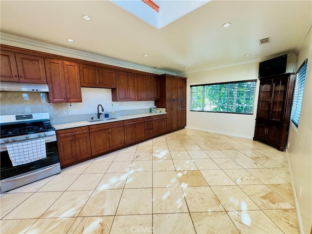 14542 Los Robles Ave, Hacienda Heights, CA 91745 - kitchen featuring gas stove, under cabinet range hood, light countertops, ornamental molding, and tasteful backsplash