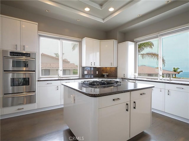 2637 Via Olivera, Palos Verdes Estates, CA 90274 - kitchen with a warming drawer, stainless steel appliances, recessed lighting, dark wood-style floors, and white cabinetry