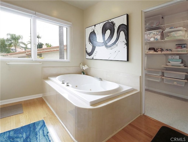 2637 Via Olivera, Palos Verdes Estates, CA 90274 - bathroom featuring wood finished floors, a tub with jets, and baseboards