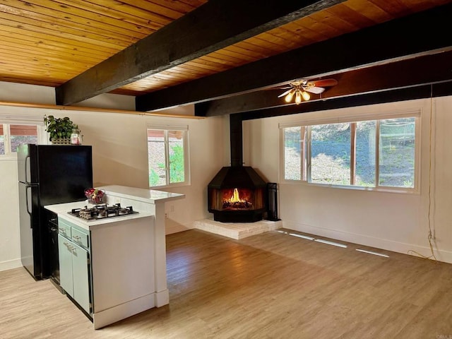 21803 Crestline Rd, Palomar Mountain, CA 92060 - kitchen featuring stainless steel gas cooktop, freestanding refrigerator, wooden ceiling with exposed beams, light countertops, and light wood finished floors
