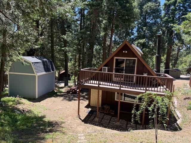 21803 Crestline Rd, Palomar Mountain, CA 92060 - rear view of property with a storage unit and a wooden deck