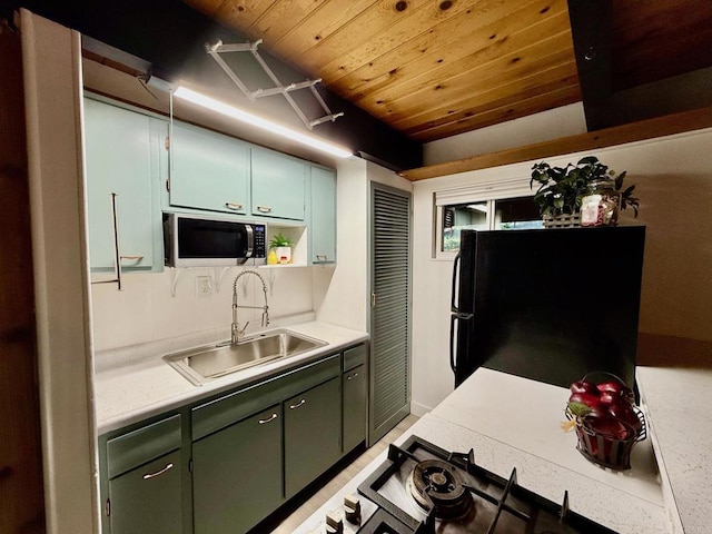 21803 Crestline Rd, Palomar Mountain, CA 92060 - kitchen featuring stainless steel microwave, freestanding refrigerator, wood ceiling, and light countertops