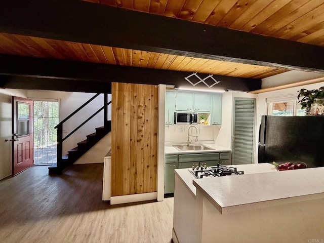 21803 Crestline Rd, Palomar Mountain, CA 92060 - kitchen featuring freestanding refrigerator, stainless steel microwave, green cabinetry, light countertops, and light wood-type flooring
