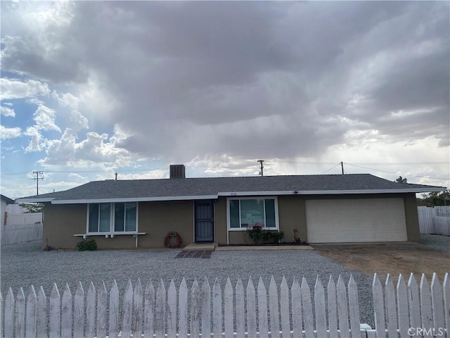 14726 Osage Rd, Apple Valley, CA 92307 - ranch-style house with driveway, stucco siding, a garage, and a shingled roof