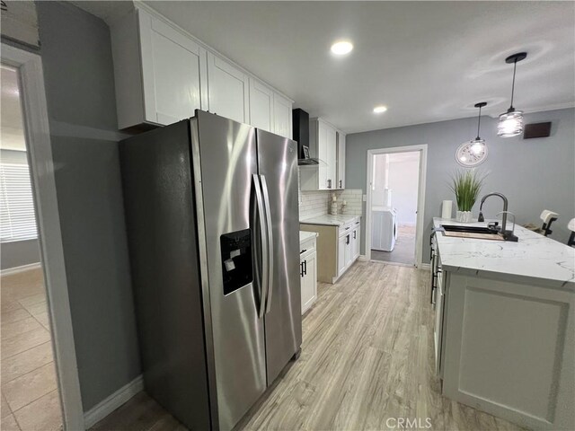 14726 Osage Rd, Apple Valley, CA 92307 - kitchen with stainless steel refrigerator with ice dispenser, white cabinetry, washer / clothes dryer, tasteful backsplash, and light stone countertops