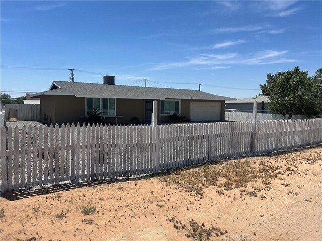 14726 Osage Rd, Apple Valley, CA 92307 - ranch-style home featuring a fenced front yard, an attached garage, stucco siding, and a shingled roof