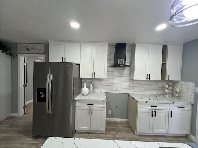 14726 Osage Rd, Apple Valley, CA 92307 - kitchen featuring stainless steel refrigerator with ice dispenser, wall chimney range hood, white cabinetry, tasteful backsplash, and open shelves