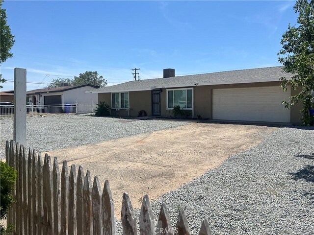 14726 Osage Rd, Apple Valley, CA 92307 - ranch-style house with an attached garage, driveway, and stucco siding