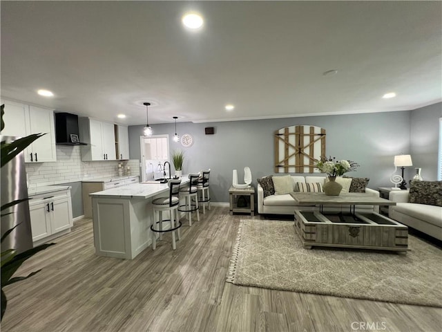 14726 Osage Rd, Apple Valley, CA 92307 - living room featuring wood finished floors, recessed lighting, and ornamental molding
