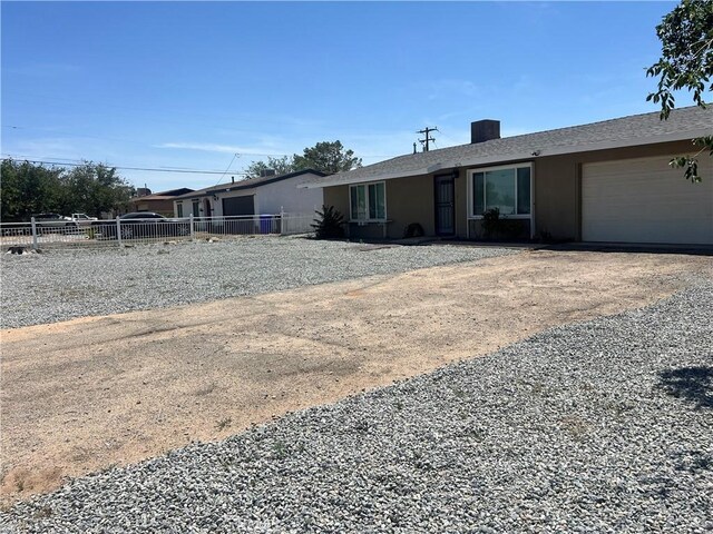 14726 Osage Rd, Apple Valley, CA 92307 - ranch-style home with a garage, stucco siding, and driveway