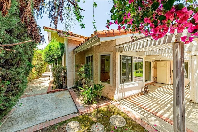 1736 Island Dr, Fullerton, CA 92833 - rear view of property with a patio area, a pergola, stucco siding, and a tile roof