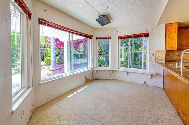 1736 Island Dr, Fullerton, CA 92833 - unfurnished sunroom featuring carpet, a textured ceiling, wallpapered walls, and a sink