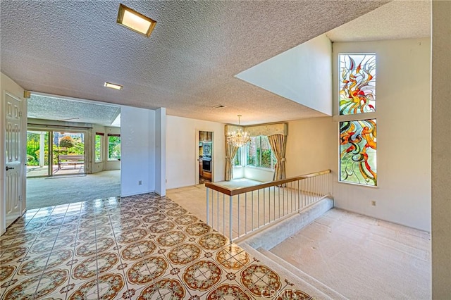 1736 Island Dr, Fullerton, CA 92833 - hallway featuring a chandelier, a textured ceiling, baseboards, and an upstairs landing