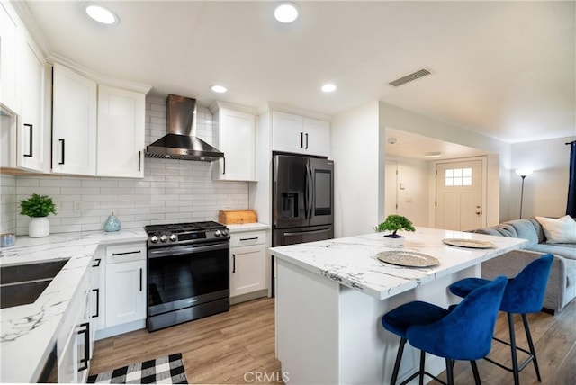 20869 Moonlake St, Walnut, CA 91789 - kitchen featuring stainless steel gas range, wall chimney exhaust hood, refrigerator with ice dispenser, open floor plan, and a kitchen breakfast bar