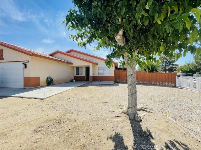 14462 Ivy St, Adelanto, CA 92301 - rear view of property featuring stucco siding and a tiled roof