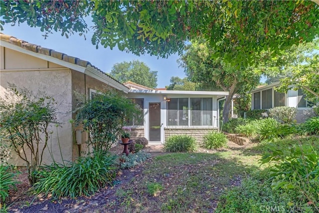 5341 Bahia Blanca W Unit C, Laguna Woods, CA 92637 - view of property exterior featuring a sunroom and stucco siding