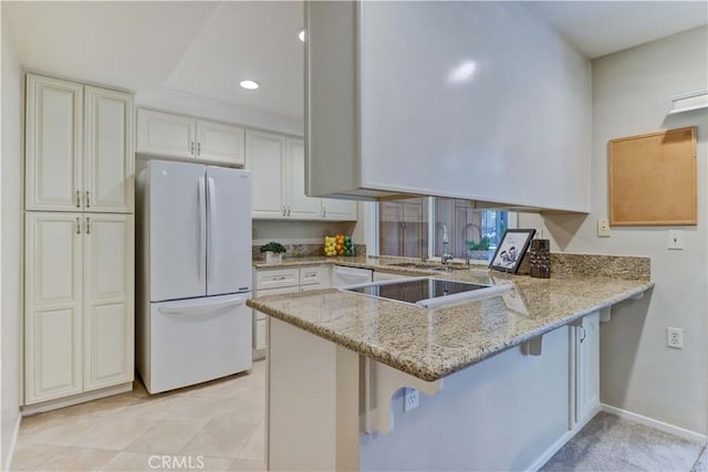 5341 Bahia Blanca W Unit C, Laguna Woods, CA 92637 - kitchen featuring white appliances, a peninsula, light stone counters, a kitchen breakfast bar, and recessed lighting
