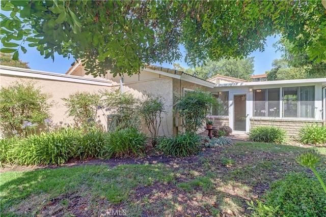 5341 Bahia Blanca W Unit C, Laguna Woods, CA 92637 - view of home's exterior featuring a sunroom and stucco siding