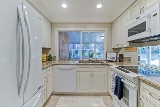 5341 Bahia Blanca W Unit C, Laguna Woods, CA 92637 - kitchen featuring white appliances, plenty of natural light, light tile patterned floors, white cabinetry, and recessed lighting