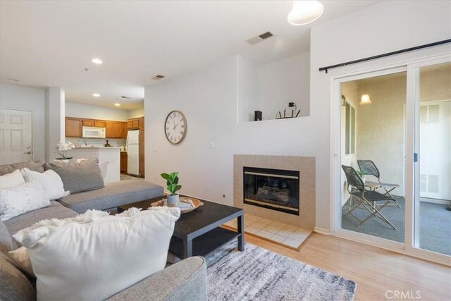 26426 Arboretum Way Unit 806, Murrieta, CA 92563 - living room featuring light wood-type flooring, a fireplace, recessed lighting, and baseboards