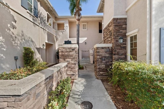 26426 Arboretum Way Unit 806, Murrieta, CA 92563 - view of exterior entry featuring stucco siding and stone siding