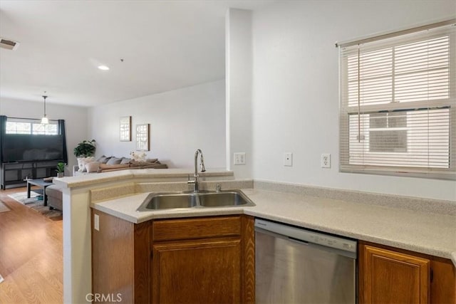 26426 Arboretum Way Unit 806, Murrieta, CA 92563 - kitchen with dishwasher, a sink, brown cabinets, open floor plan, and light countertops
