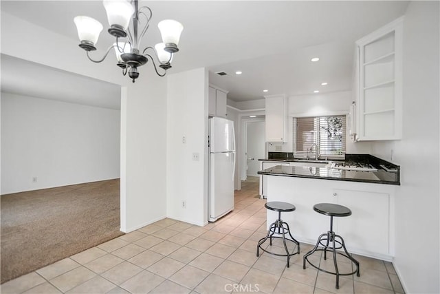 806 E Laurel Oak Dr, Azusa, CA 91702 - kitchen featuring freestanding refrigerator, light colored carpet, dark countertops, a peninsula, and a chandelier