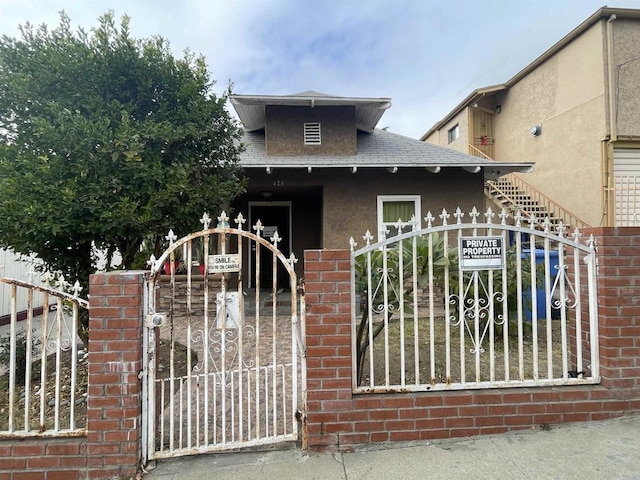 425 N Westlake Ave, Los Angeles, CA 90026 - view of front of house with a gate, a shingled roof, stucco siding, and brick siding