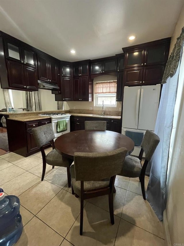 425 N Westlake Ave, Los Angeles, CA 90026 - kitchen with white appliances, light tile patterned floors, recessed lighting, under cabinet range hood, and light countertops