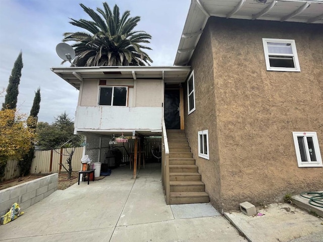 425 N Westlake Ave, Los Angeles, CA 90026 - rear view of house with stucco siding, stairs, and a patio area