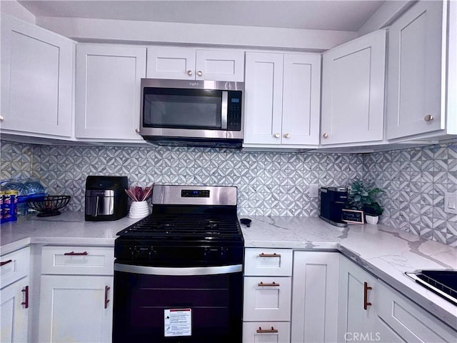 2969 Crestwood Pl, Riverside, CA 92503 - kitchen featuring appliances with stainless steel finishes, white cabinets, and light stone countertops