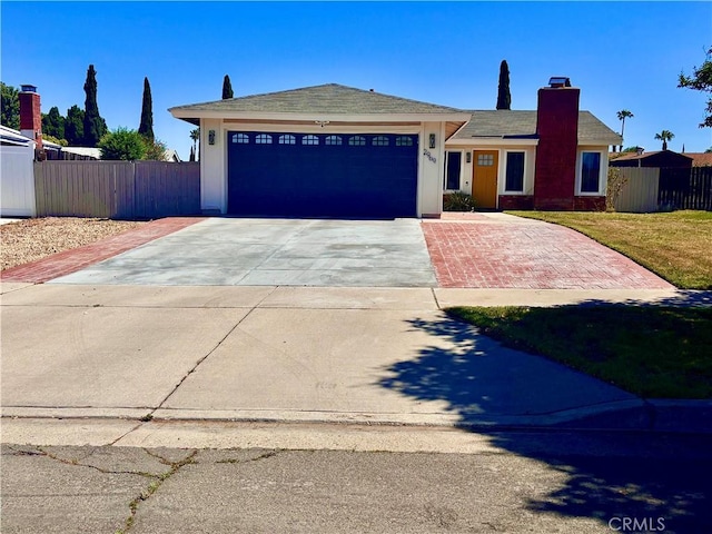 2969 Crestwood Pl, Riverside, CA 92503 - view of front of home featuring driveway, an attached garage, a chimney, and a shingled roof