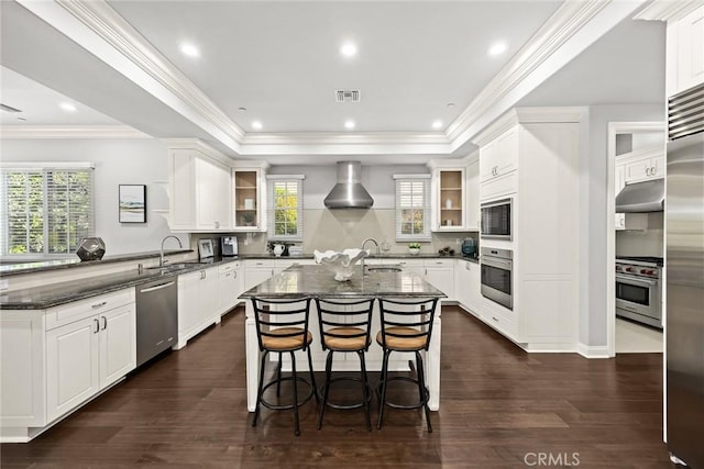 2600 S 2nd Ave, Arcadia, CA 91006 - kitchen featuring built in appliances, under cabinet range hood, a kitchen island with sink, a raised ceiling, and dark stone countertops